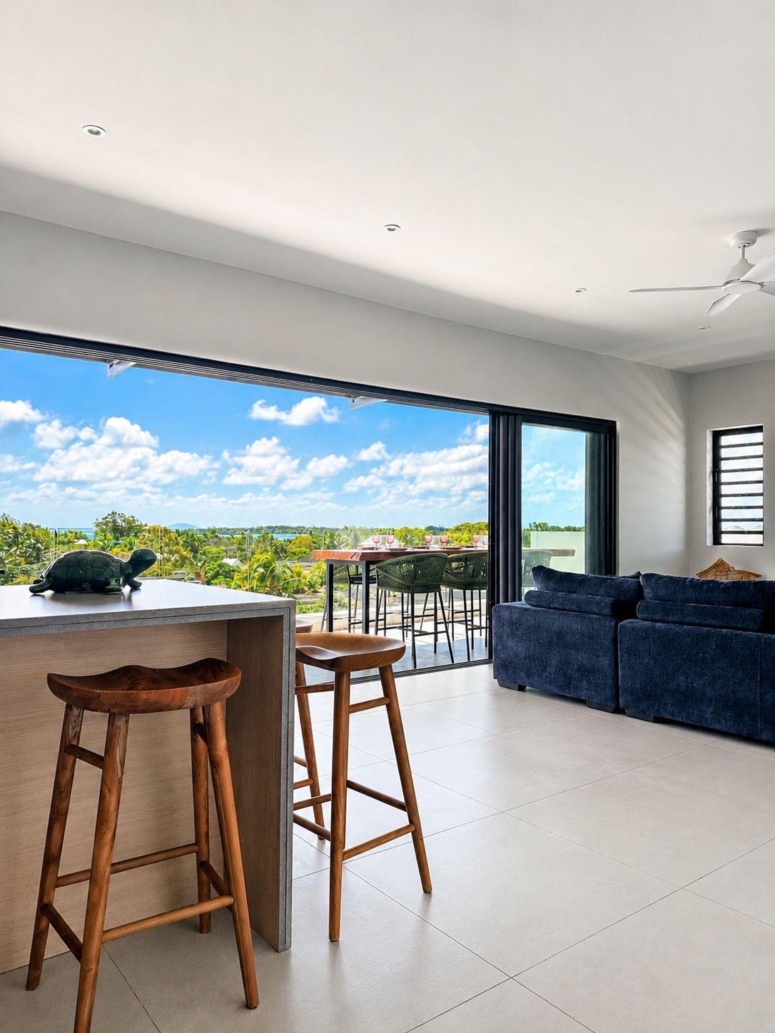 Open-plan living and kitchen with contemporary design extending onto the terrace